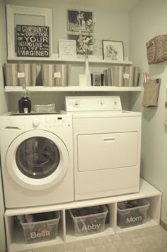 a washer and dryer in a small room with shelves above the washer