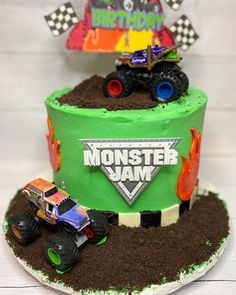 a monster jam birthday cake with trucks on top and dirt in the middle for decoration