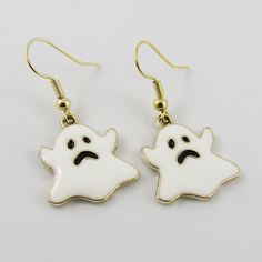 Cute n Kitsch Charm Hook Earrings with Enamel Spooky Ghost Charms       Materials:     Earring Hooks - Brass   Charms - Alloy & Enamel      Approx. Total Earring Length: 35 mm Fun White Halloween Jewelry, Fun White Jewelry For Halloween, Novelty White Dangle Earrings, Novelty White Earrings For Pierced Ears, White Novelty Dangle Jewelry, Novelty White Dangle Jewelry, Novelty White Pierced Jewelry, Halloween Themed White Earrings, Fun White Halloween Earrings