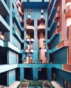 the inside of an apartment building with lots of windows and balconies on each floor