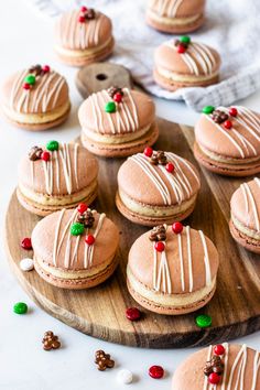 gingerbread macarons with white icing on a wooden platter