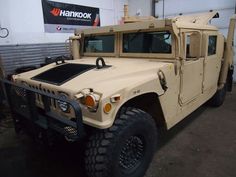 an army vehicle is parked in a garage