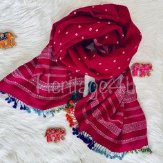 A Kutchie shawl is a traditional woven in the Kutch region of Gujarat, India. These are largely woven with kutchie Motifs in Bhujodi village of kutch. Beautiful Pink shawl with Bandhej and woven embroidery with beautiful multi color tassels. Handloom Indian wool You can style so many ways, as a scarf , as throw, and or wear it as a shawl. 2.27 meters long including tassels 90cm wide This shawls are handmade, so expect to have some irregularities which is the Beauty of it. More colors coming soon Woven Embroidery, Pink Shawl, Shawl Scarf, Blue Polka Dots, Shawls And Wraps, Scarf Shawl, Cloth Bags, Plaid Scarf, Scarf Wrap