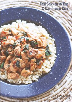 a blue plate topped with rice and chicken