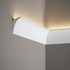 a light that is on in the corner of a wall next to a lamp fixture