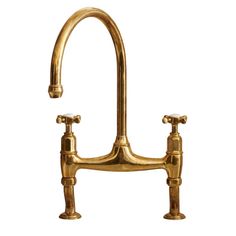 an antique brass faucet with two handles