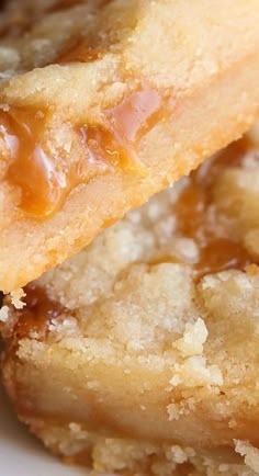 two pieces of cake sitting on top of each other in front of another piece of pie