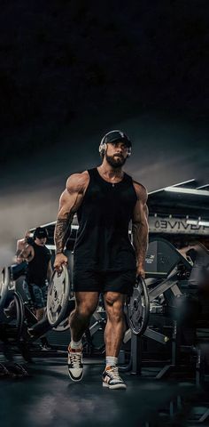 a man in black shirt and shorts holding a barbell