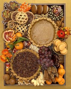 a box filled with lots of different types of pies and other food on top of it