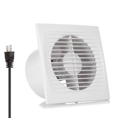 a white exhaust fan sitting on top of a table next to a black cord and an electrical outlet