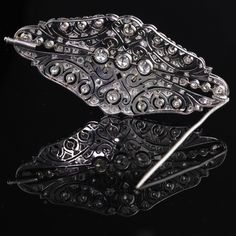 Stunning Art Deco Platinum & Diamond Brooch with beautiful delicate filigree work and milgraining. Item #JP-P0011 Metal: Platinum Weight: 17.3 Grams Diamond Weight: Approximately 4 cts of old european cut & rose cut diamonds Diamond Color: I Diamond Clarity: SI2 Measurements: 33 x 70 mm Layaway: For your convenience, we will be happy to provide layaway payment options. Please contact us to work out a layaway plan which best suits your needs. All layaway purchases are final sale. All dome Formal Diamond Brooch With Intricate Design, Classic Wedding Brooches With Intricate Design, Formal Diamond Brooches With Intricate Design, Victorian Diamond Filigree Brooches, Ornate Diamond Brooch For Formal Occasions, Ornate Diamond Brooch For Formal Wear, Ornate Diamond Brooches For Formal Occasions, Elegant White Gold Brooch With Intricate Design, Wedding Brooch With Intricate Diamond Design