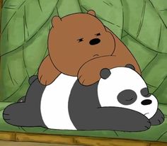 a brown bear sitting on top of a black and white panda laying on it's back