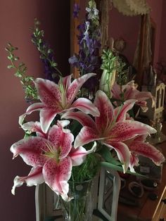 a vase filled with pink flowers on top of a table