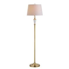 a gold floor lamp with a white shade