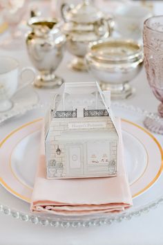 the table is set with dishes, cups and saucers for tea or desserts