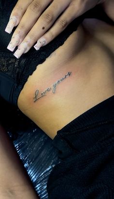 a woman's stomach with the words love you written on it and her hand