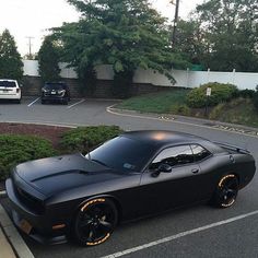 a black sports car parked in a parking lot