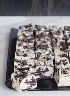 chocolate and white cake sitting on top of a black plate