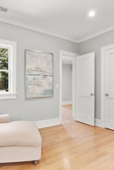 an empty living room with hard wood floors