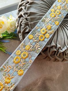 a close up of a ribbon with flowers on it