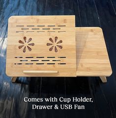 two wooden trays with holes in them sitting on top of a black table next to the words, comes with cup holder, drawer & usb fan