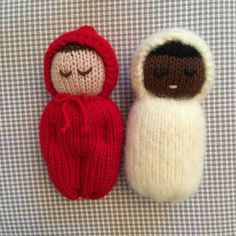 two knitted dolls sitting next to each other