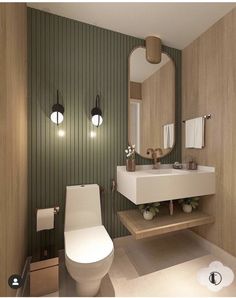 a bathroom with a toilet, sink and green striped wallpaper on the walls is shown