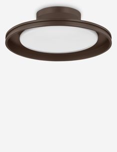 a round light fixture on a white wall