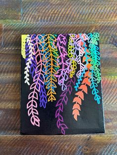 an art project with colored leaves on black paper