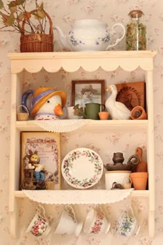 a shelf filled with dishes and cups on top of it