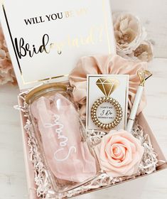 the bride gift box is filled with pink flowers and personalized items, including a ring