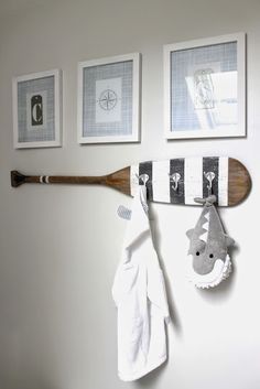 a wooden baseball bat mounted to the side of a wall next to towels and pictures