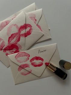 two envelopes with lipstick kisses on them