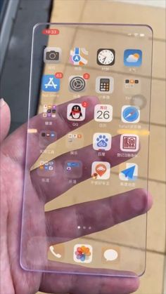 a person holding an iphone in their hand with various app icons on the display screen