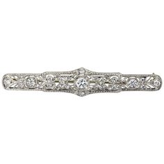 A long panel brooch of open-work design set with old European cut diamonds weighing 0.88 carats total. Hand-engraved with an intricate design. Made in platinum. Diamond Flower Brooch, Gold Star Pendant, Brooch Art, Victorian Pendants, Art Deco Brooch, Diamond Pendant Sets, Beautiful Bracelets, Work Design