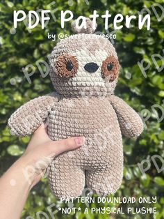 a crocheted stuffed slotty bear is being held by someone's hand