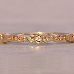 The Bleu: Yellow Gold Ladies Claddagh Band. This Elegant Claddagh Band Features The Iconic Claddagh Center, Symbolizing Love, Loyalty, And Friendship. The Design Is Enhanced By Navette-Shaped Sections Set With Round Brilliant-Cut Natural Diamonds, Adding A Touch Of Sparkle And Completing The Sophisticated Look. Crafted In 14-Karat Yellow Gold, This Band Is Currently A Size 6.75 But Can Be Resized To Fit Any Finger For An Additional Fee Upon Request. This Timeless Piece Is Perfect For Those Who Appreciate Both Tradition And Elegance In Their Jewelry. Diamond Claddagh Ring, Claddagh Ring, Claddagh Rings, Womens Jewelry Rings, Round Brilliant, Timeless Pieces, Natural Diamonds, Diamonds, Sparkle