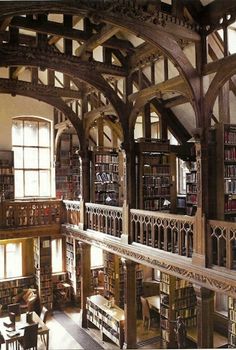 an old library with many bookshelves and tables