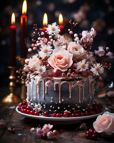 a cake decorated with flowers and candles on a table