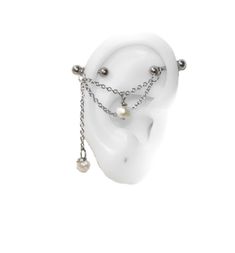 a pair of ear piercings with pearls and chains