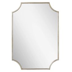 a mirror that is sitting on top of a white wall mounted shelf with a metal frame