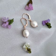 ✦Stunning but simple white natural white teardrop freshwater pearls hang from 14k rose gold filled leverback ear wires. The freshwater pearls have a slight white color and are teardop in shape. The pearls measure approximately 11mm in length and 9mm in diameter.  They dangle about 1-1/4 inches from the top of the ear wire to the bottom of the pearl.  ✦Your jewelry will be packaged in a beautiful and reusable organza bag. All items will be placed in the same organza bag. If you need a separate bag for each item, please leave a comment at check out. ✦Giving your purchase as a gift? If you would prefer that prices not be printed on your invoice, please check "this item is a gift".  ✦To receive your item in a gift box with a colorful ribbon, please purchase the gift wrapping option at check ou Delicate Oval Pearl Drop Jewelry, Teardrop Pearl Earrings With Lever Back For Wedding, Rose Gold Teardrop Pearl Earrings As Gift, Rose Gold Pearl Earrings With Ear Wire For Anniversary, Rose Gold Jewelry With French Hook As A Gift, Classic Rose Gold Jewelry With Pearl Drop, Rose Gold Wedding Jewelry With Lever Back Ear Wires, Rose Gold Jewelry With French Hook For Gift, Rose Gold Jewelry With Pearl Drop