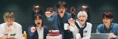 group of young men sitting around a cake