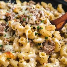 a skillet filled with pasta, meat and cheese