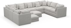 a large sectional couch with several pillows on the top and bottom, sitting in front of a white background