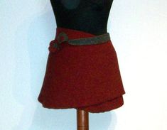 a mannequin wearing a red skirt with a gray belt on it's waist