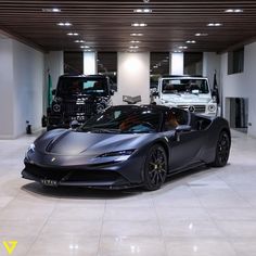 a black sports car is parked in a showroom