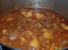 a pot filled with stew sitting on top of a stove