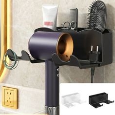 the hair dryer is attached to the wall next to the brush and toothbrush holder