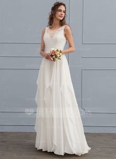 a woman in a white dress standing on a wooden floor